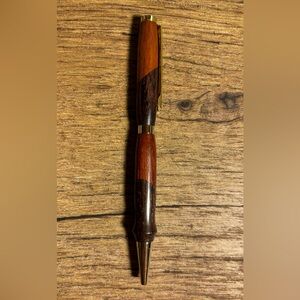 Beautiful Hand turned 2 tone ink pen. Smooth writing black ink. Gold accents.